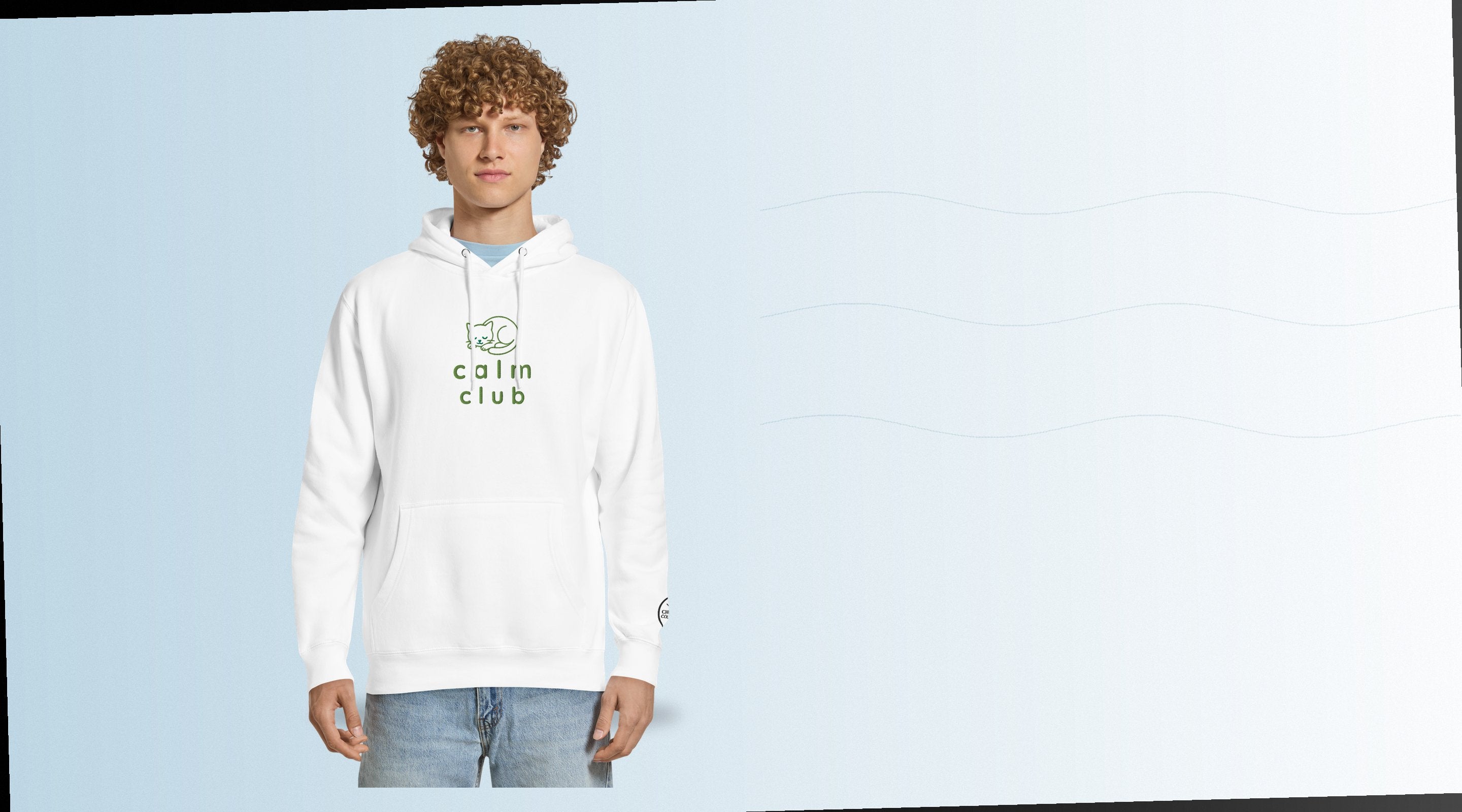 Person wearing a white hoodie with CALM CLUB Cat embroidery on a soft blue background.